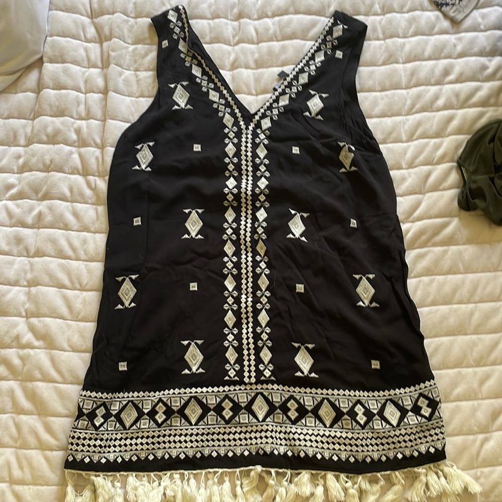 Black dress with a embroidered pattern along the front